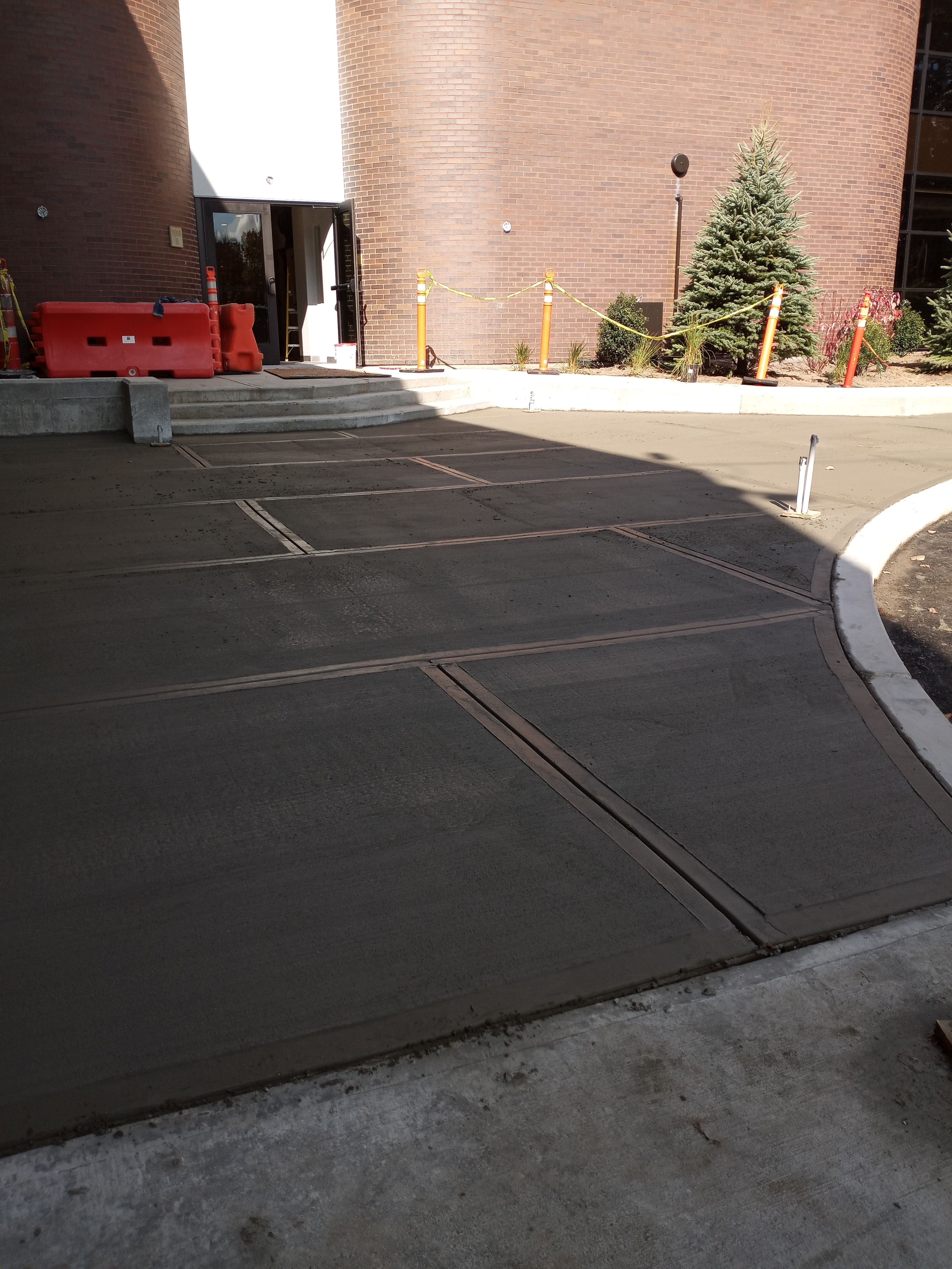 Outdoor image of wet concrete drying in the summer sun. All in a days work for TD Construction.